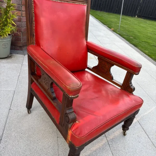 Victorian red leather armchair with floral carved oak frame