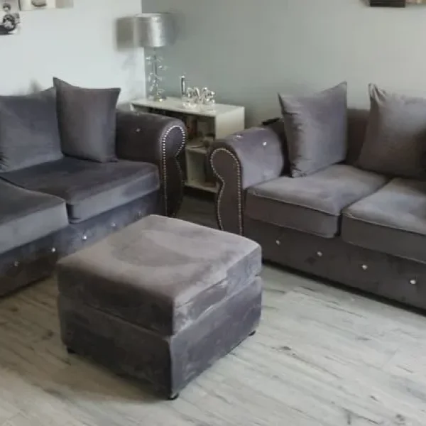 Slate gray chesterfield style sofa set with footstool