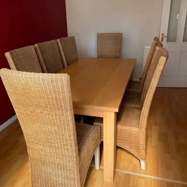 Oak dining table and 8 sprung wicker chairs