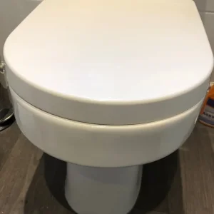Two white toilets and a white hand basin - Image 3