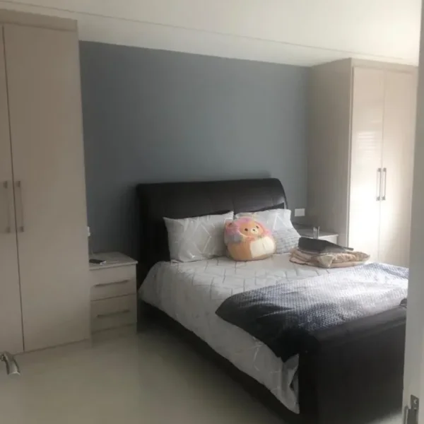 Large bedroom with fitted wardrobes and dressing table