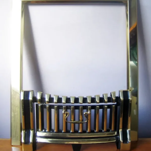 Brass fender with black enamel surround