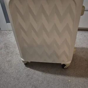 Colsilation cream suitcase and black and grey suitcase