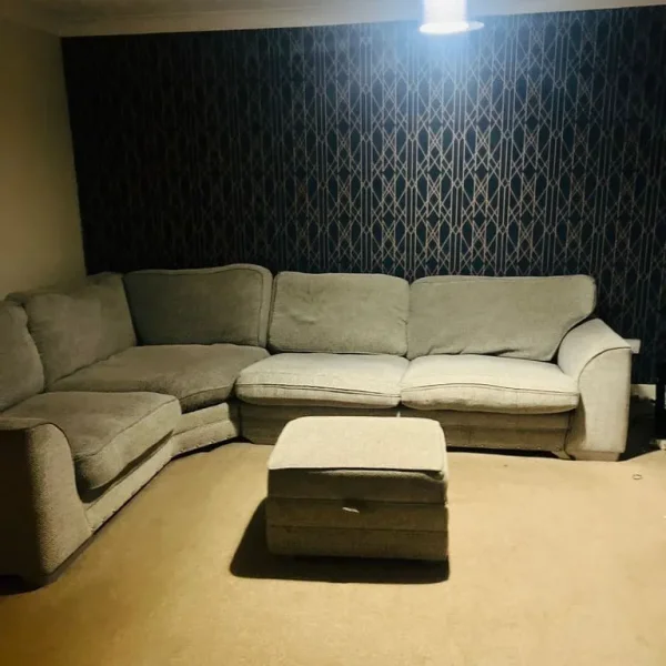 Corner sofa with footstool