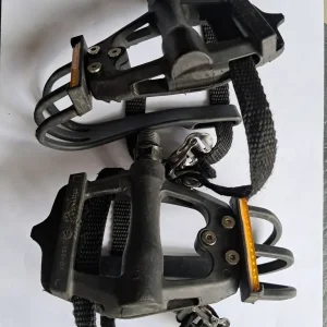 Pair of black bike pedals, toe caged with straps - Image 2