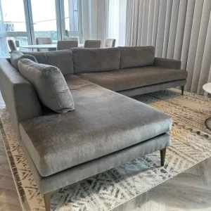 West Elm L-shaped grey sofa with brushed velvet and gold legs