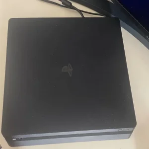 PS4 console with two controllers and three games - Image 2