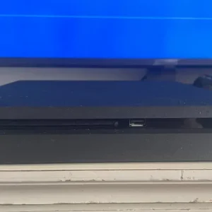PS4 console with two controllers and three games - Image 4