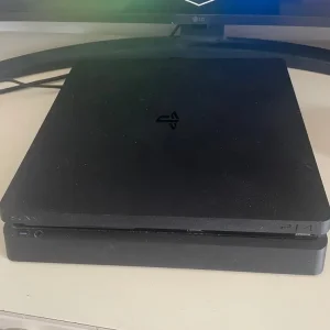 PS4 console with two controllers and three games