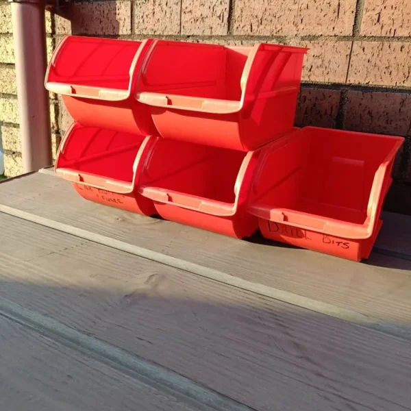 5 red plastic stacking storage bins