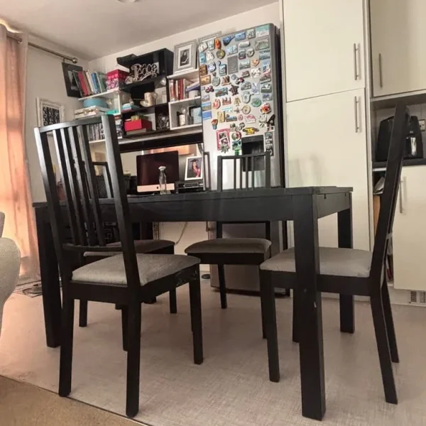 IKEA black extendable dining table with 4 chairs