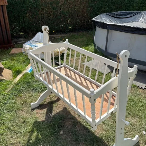 White swinging baby crib