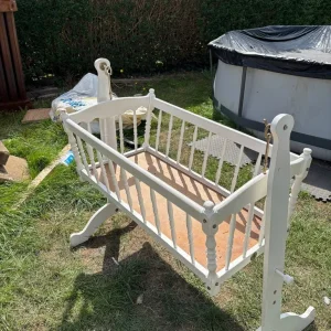 White swinging baby crib