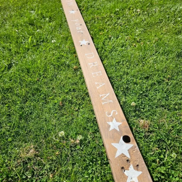 Wooden sign with "follow your dreams" message