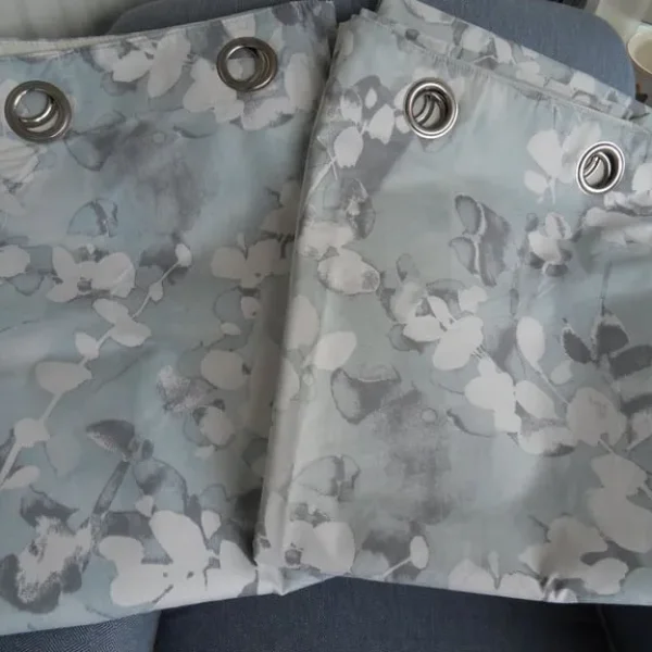Pair of long floral Dunelm lined eyelet curtains