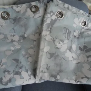 Pair of long floral Dunelm lined eyelet curtains