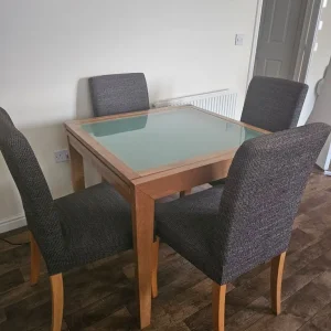 Glass extending dining room table plus 4 dark grey IKEA chairs