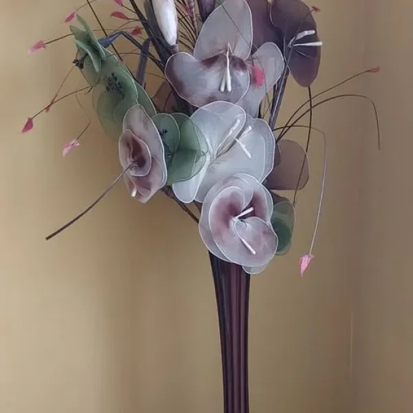 Artificial flowers in a glass vase