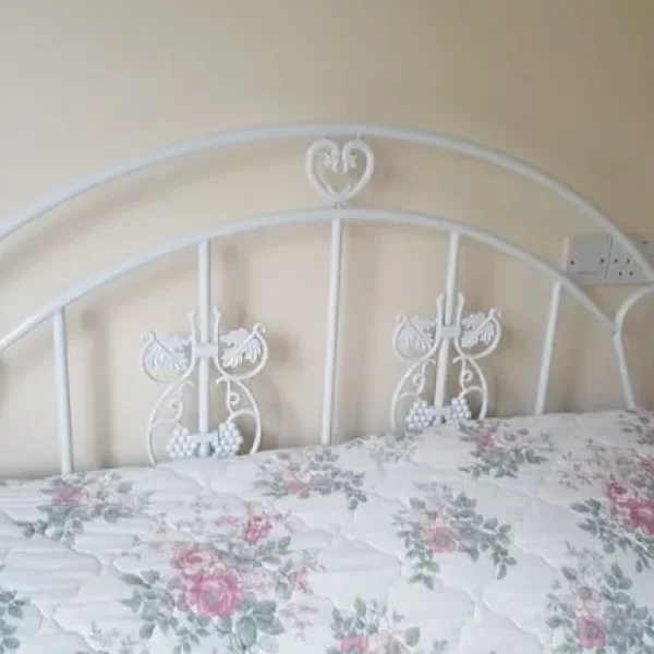 White bed frame with double mattress