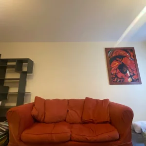 Three-seater red fabric sofa bed