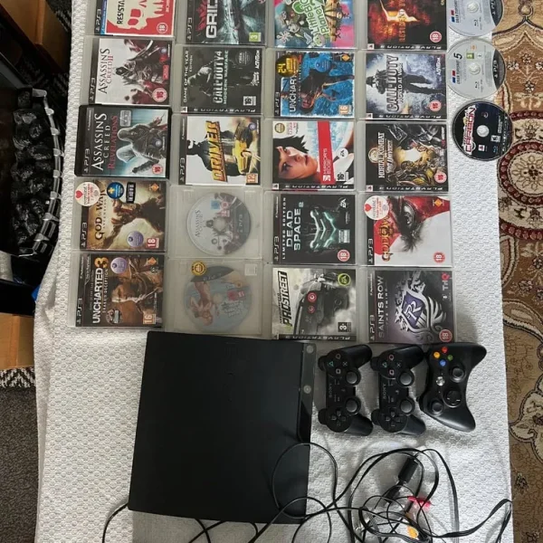 PlayStation 3 with 28 games, 2 controllers, and an Xbox controller