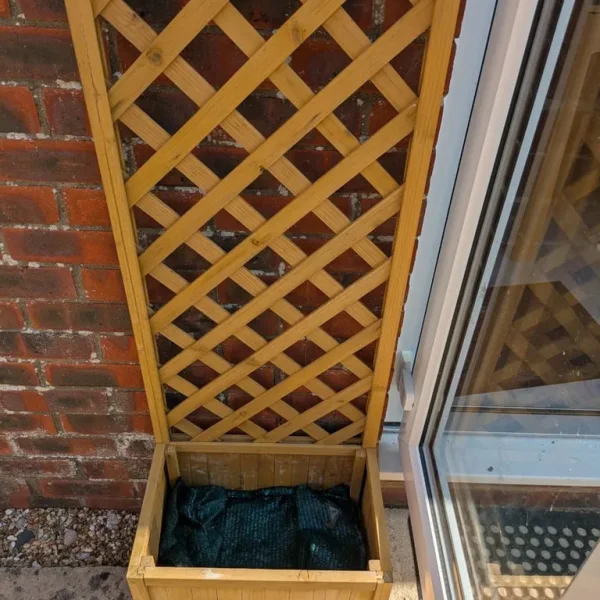 Small wooden garden planter with trellis back