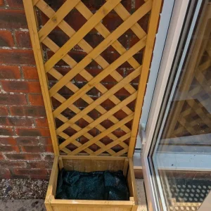 Small wooden garden planter with trellis back