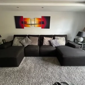 2 x large black modular sofas by Living Interiors