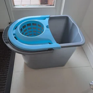 Grey and blue mop bucket, one small crack