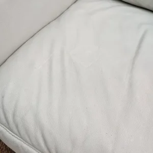 Comfy white real leather armchair and footstool