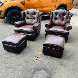 Beautiful pair of chesterfield oxblood leather armchairs with matching footstools