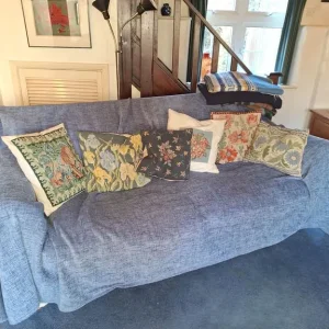 Cream sofa with blue throw blanket - Image 2