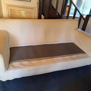 Cream sofa with blue throw blanket - Image 3