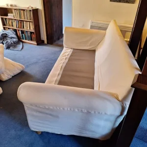 Cream sofa with blue throw blanket - Image 4