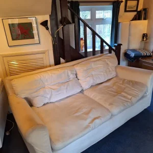 Cream sofa with blue throw blanket