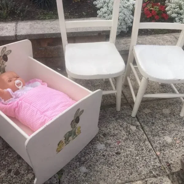 Wooden cot with doll and two kids' chairs