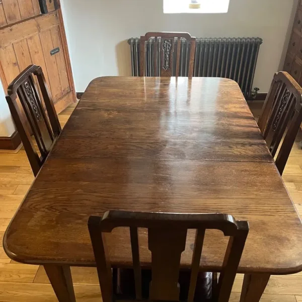 Solid oak dining table and four chairs