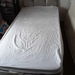 Grey fabric single bed with headboard