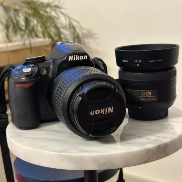 Nikon D3100 with 18-55mm and 35mm lens, tripod, bag
