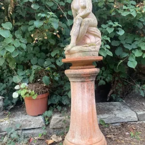 Terracotta garden figure on stand