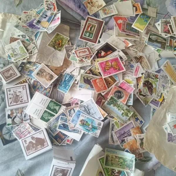 Selection of stamps and vintage tin