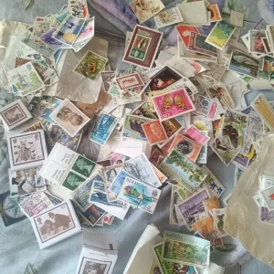Selection of stamps and vintage tin