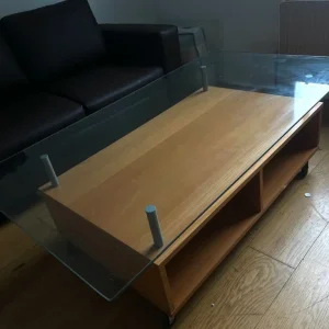 Glass table on wheels with storage