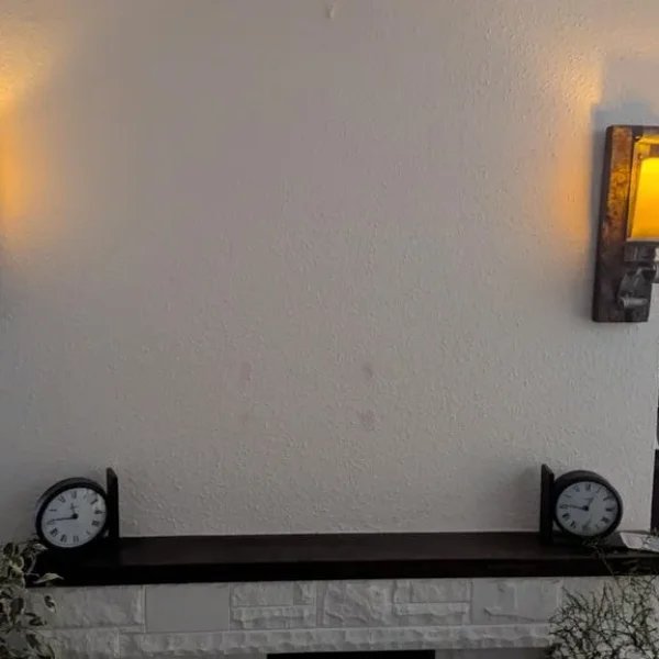Pair of wall-mounted metal and teak candle holders