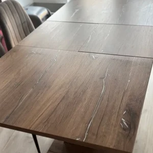 Dining table with wood finish, extends to 8 seats