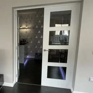 Pair of internal white gloss glass panel french doors with brushed chrome handles