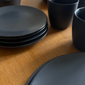 Black set of dinnerware plates, bowls, mugs