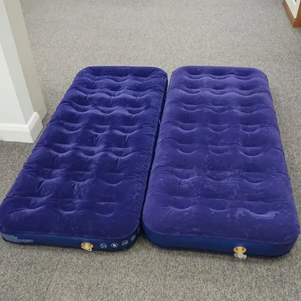 Camping two single air beds that zip together
