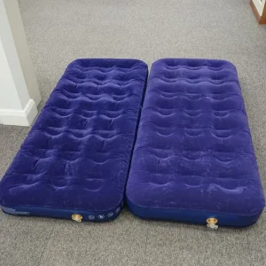 Camping two single air beds that zip together
