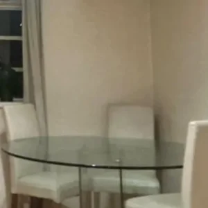 glass dining table with cream leather chairs
